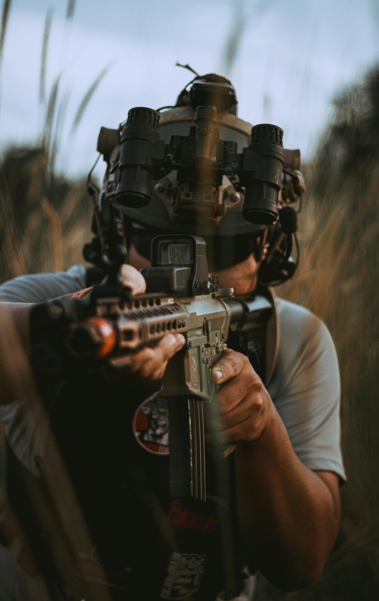 Close-up of a person aiming a rifle outdoors, focusing on the firearm's detail.