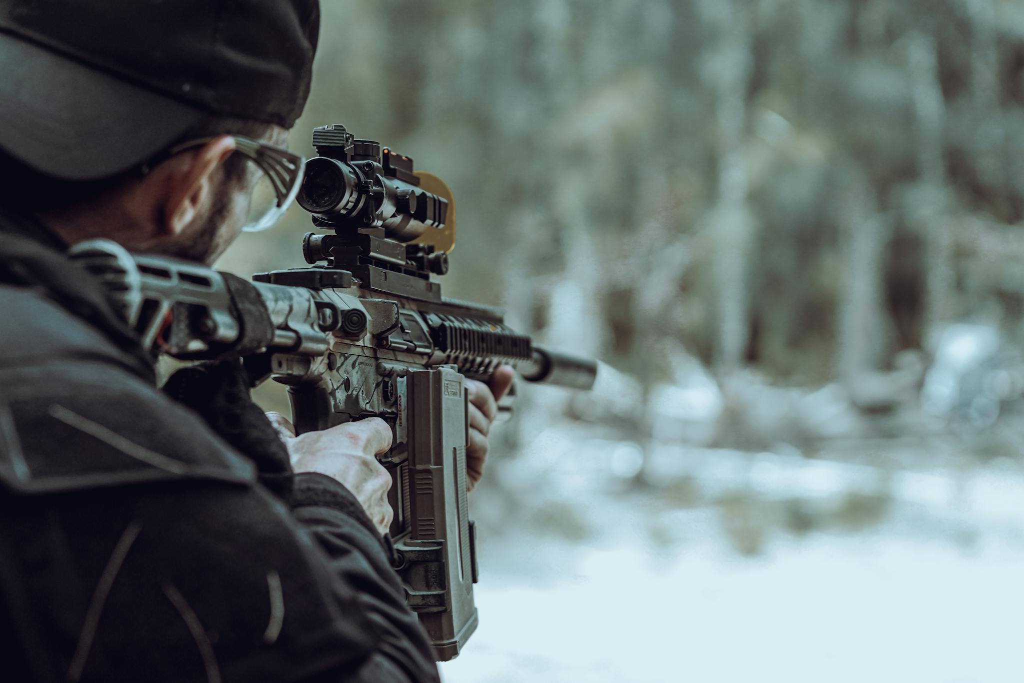 Man aiming rifle outdoors with a focus on target practice and firearm safety.